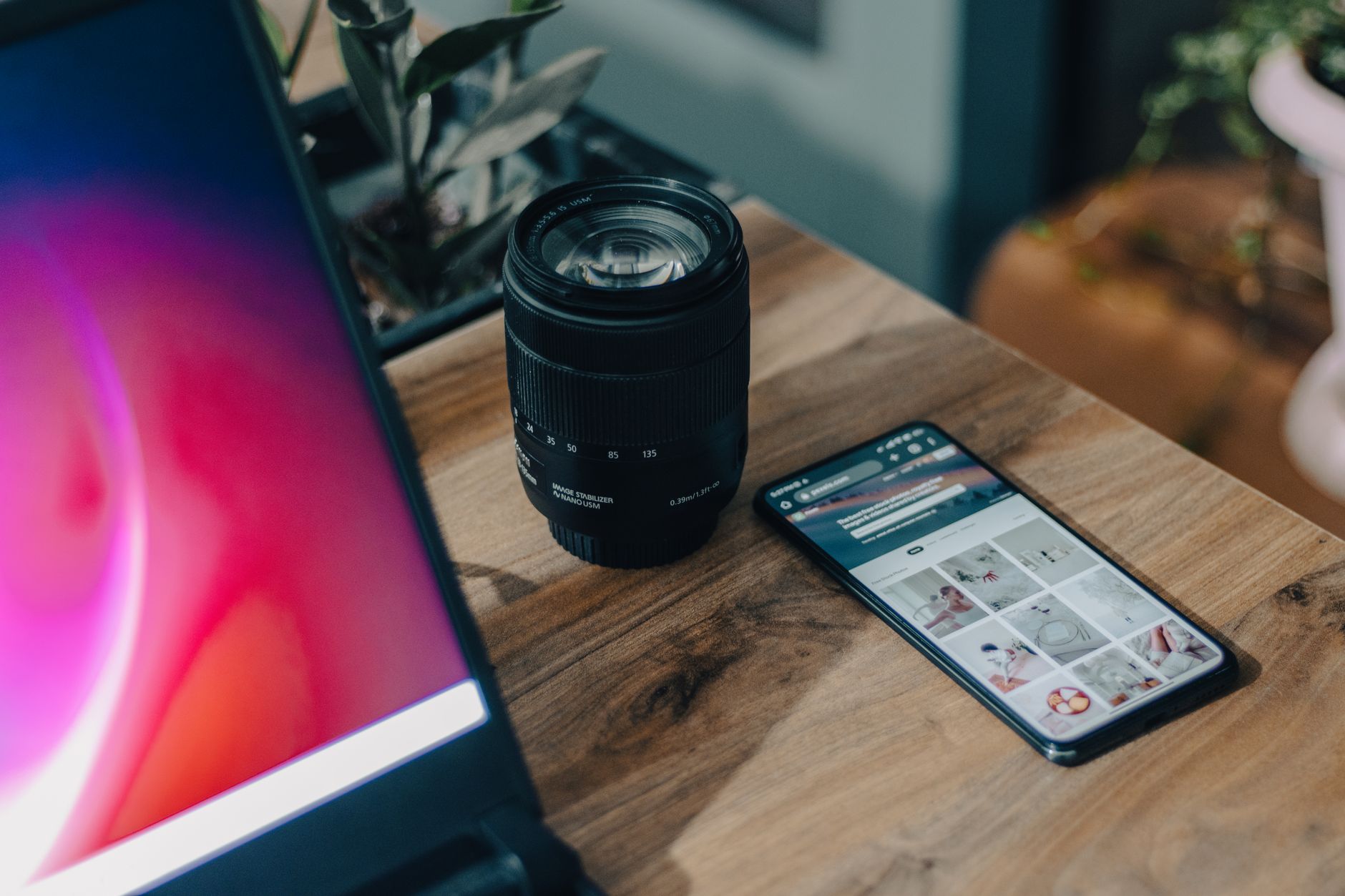 a smartphone screen displaying a social media feed with multiple AI-generated photorealistic images in a grid layout, placed on a wooden desk beside a cup of coffee