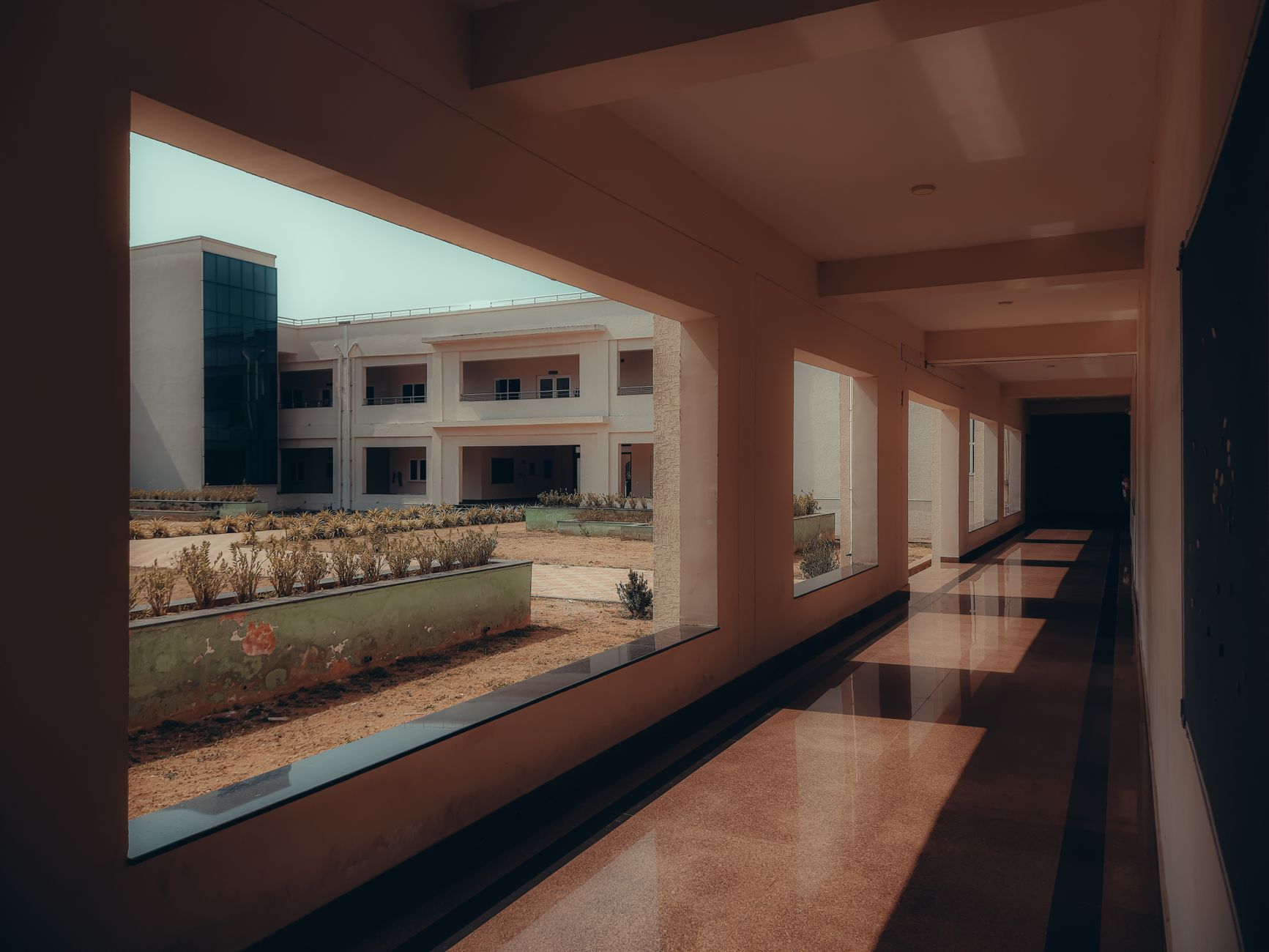 rows of whiteboards covered in hand-written mathematical proofs inside an empty research institute corridor, afternoon light coming through tall windows