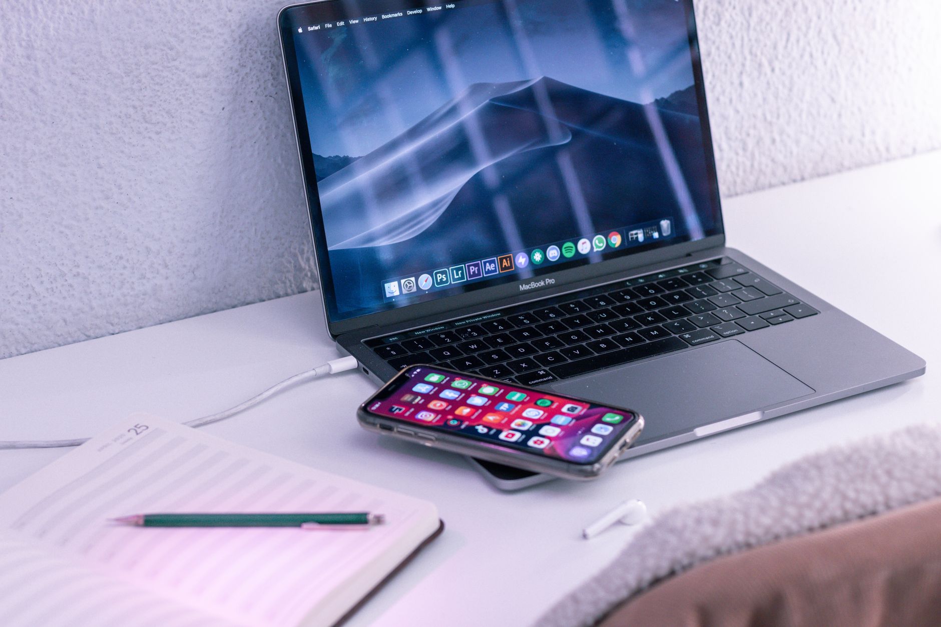 a sleek titanium smart ring resting on a wireless charging pad beside a smartphone displaying health metrics on screen