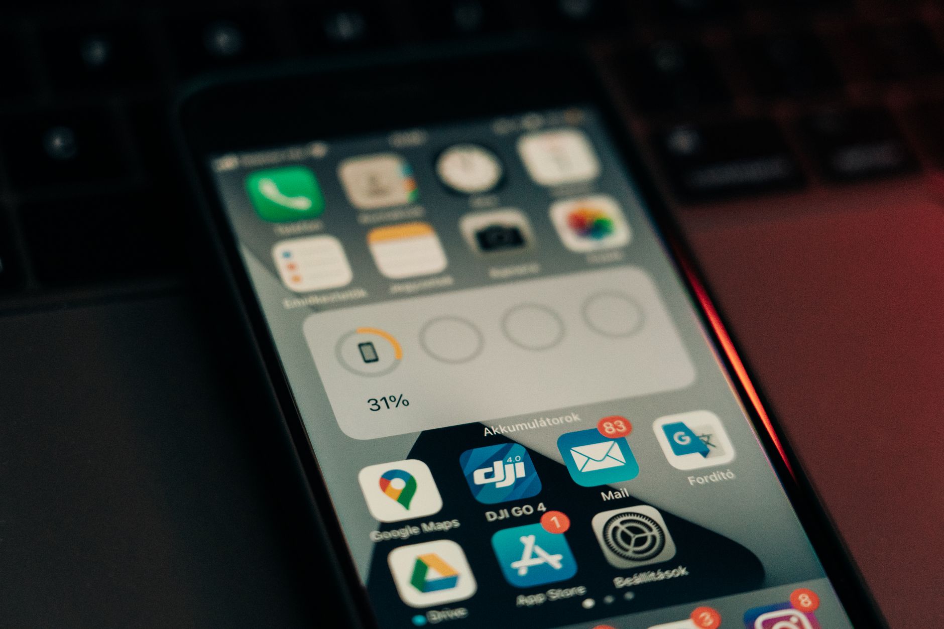 a smartphone screen displaying an Instagram feed with a sponsored post from a lifestyle brand, surrounded by comment notification badges on a wooden desk