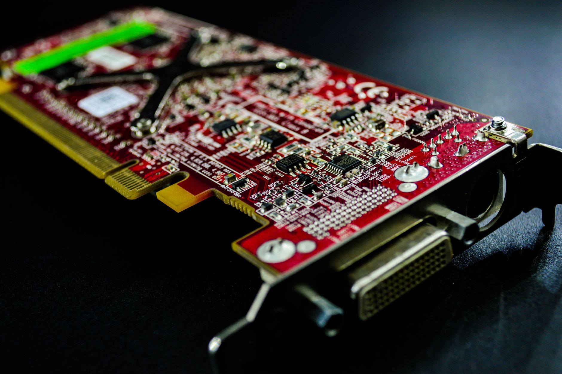 a close-up of an FPGA-based network interface card mounted in a server chassis, with heat spreaders and high-density connectors visible against a dark motherboard background